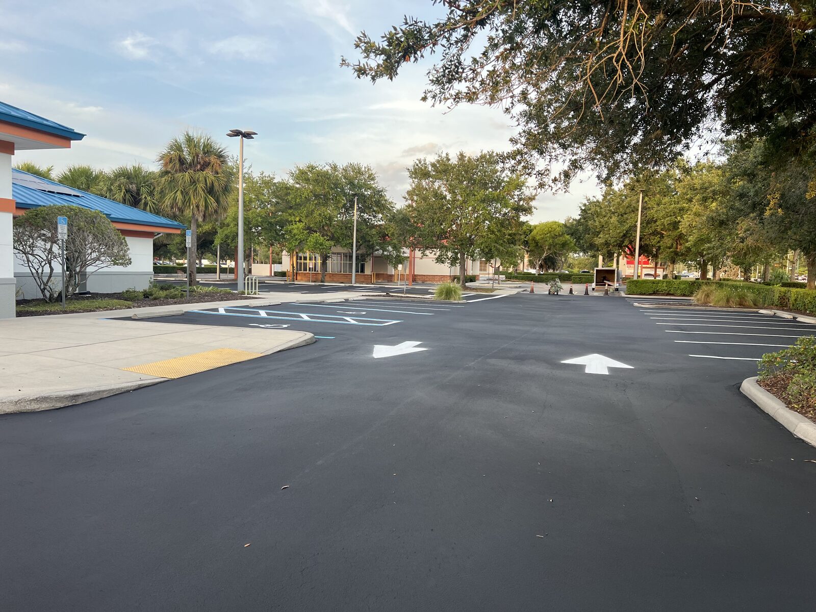 Completed commercial parking lot with fresh sealcoat and line striping